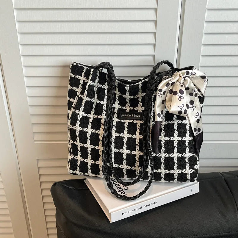 Black woolen horizontal square shoulder bag with weaving detail exterior and internal organisation compartments
