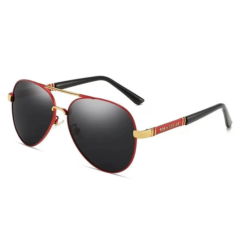 Gold frame men's polarised sunglasses with dragon-phoenix temple detail and grey lenses on a table.