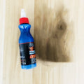 Blue automotive scratch repair agent kit with bottle and applicator for vehicle paint touch-up