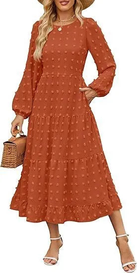 A woman wearing a beige high waist long sleeve dress with ruffled sleeves, a round neck, and a solid colour design.