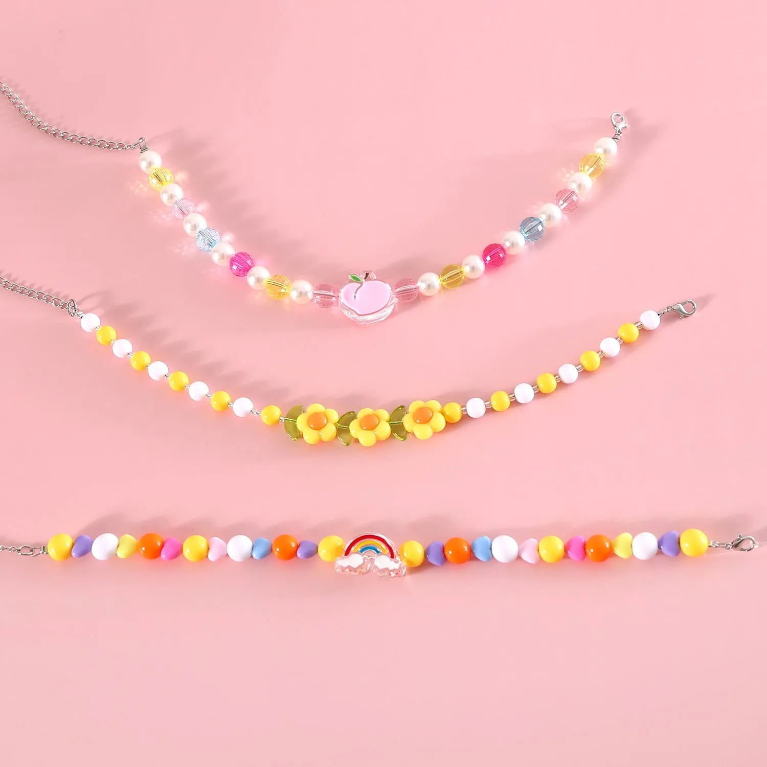 Colourful plastic bead cat collar with adjustable sizing in peach, rainbow, or small flower patterns