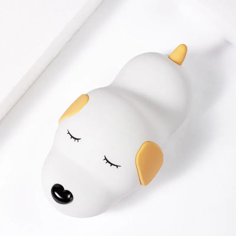 Cute silicone dog night lamp with two-color USB charging light on a wooden table