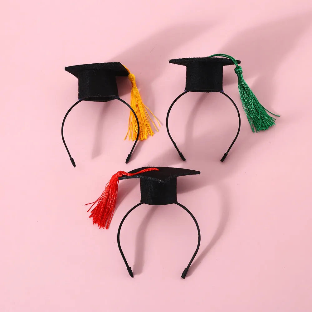 A British-style elastic hair band and matching felt bow tie for a small dog or cat, shown in a selection of colours.