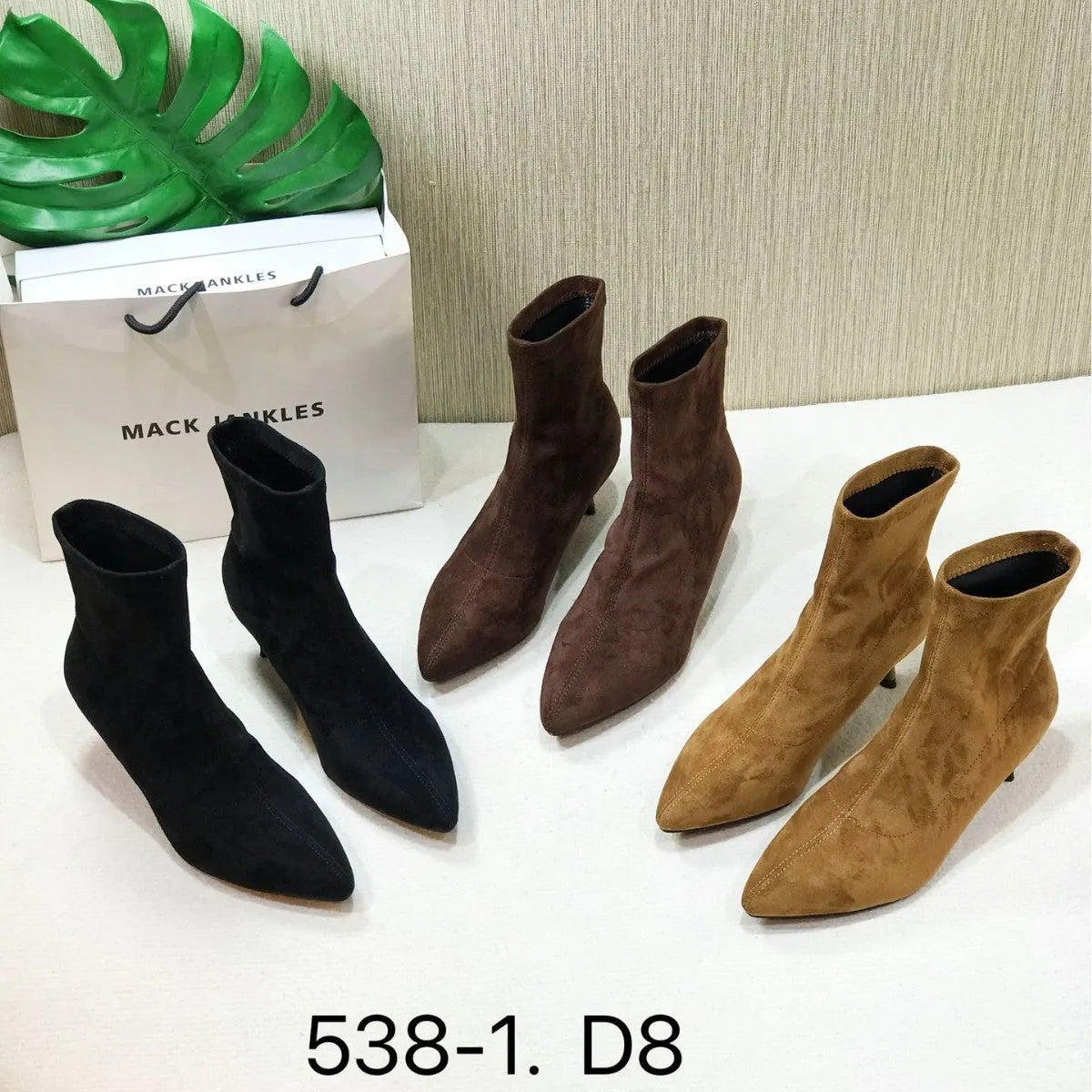 Black pointed toe women's ankle boots with a stiletto heel on a mid-calf shaft.