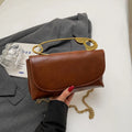 Creative personality paper clip shoulder handbag in PU leather with sandwich pocket and file bag interior.