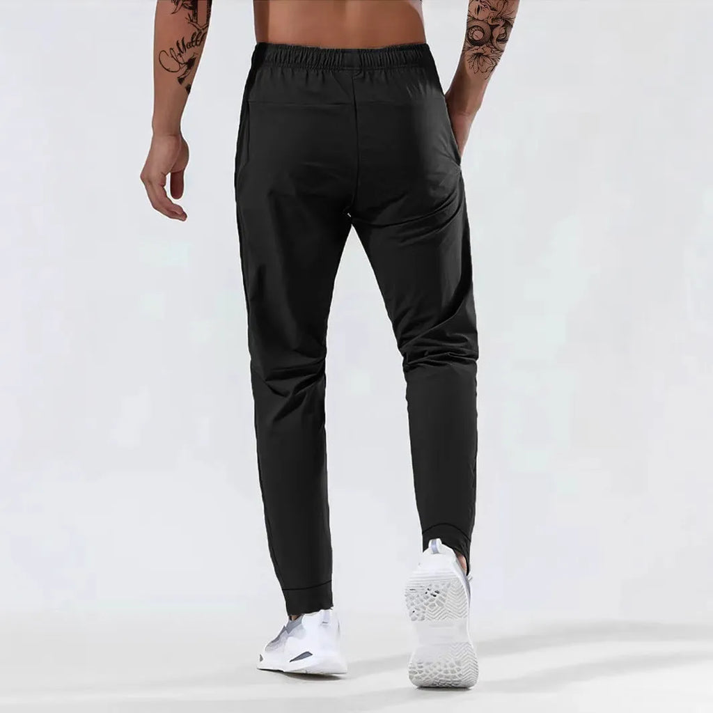 Men's loose mid waist jogging sports pants in black, grey, khaki, or blue, high elasticity nylon blend, sizes L to 7XL