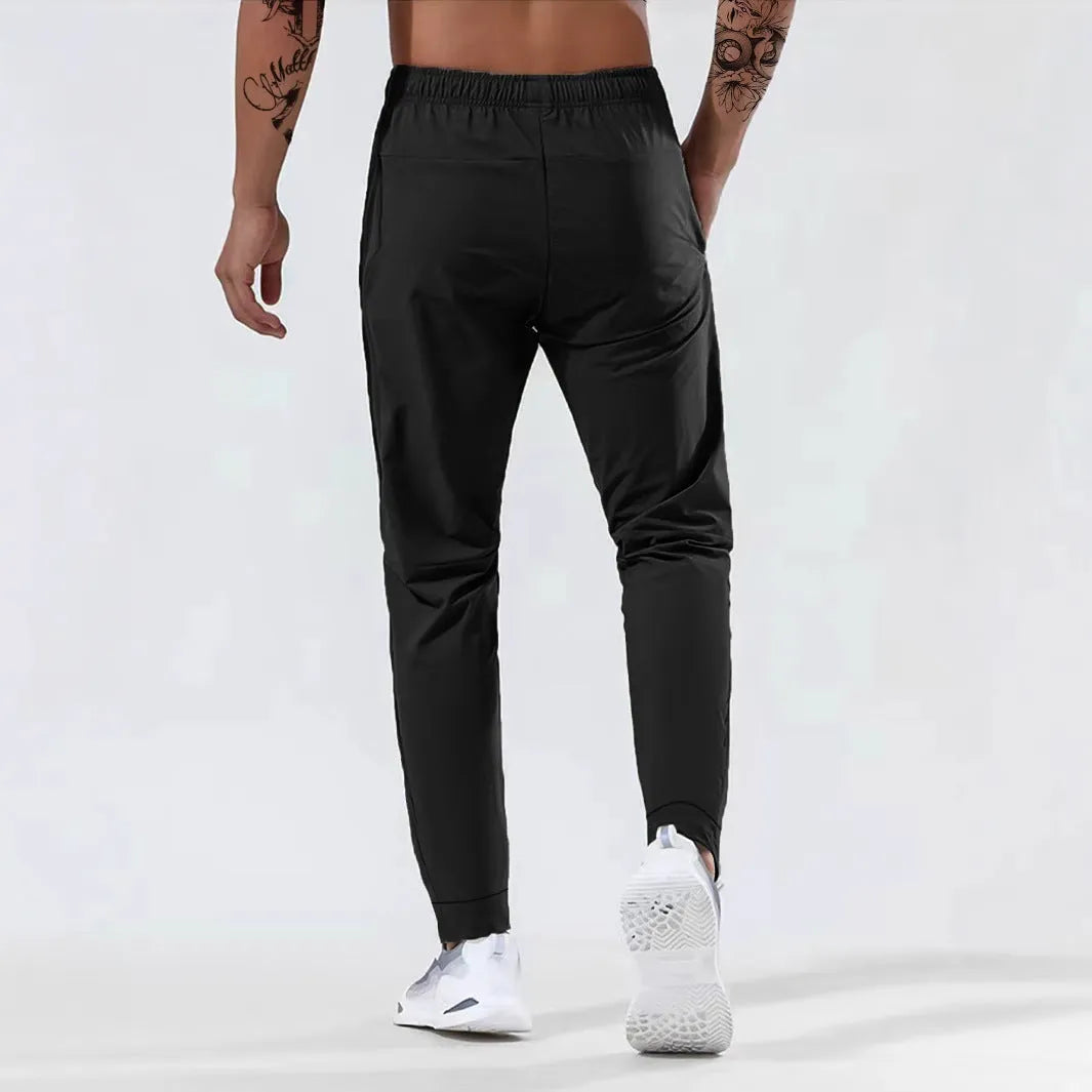 Men's loose mid waist jogging sports pants in black, grey, khaki, or blue, high elasticity nylon blend, sizes L to 7XL