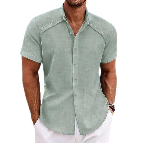 Man wearing a solid colour Hawaiian casual short sleeve shirt in a cotton blend fabric.
