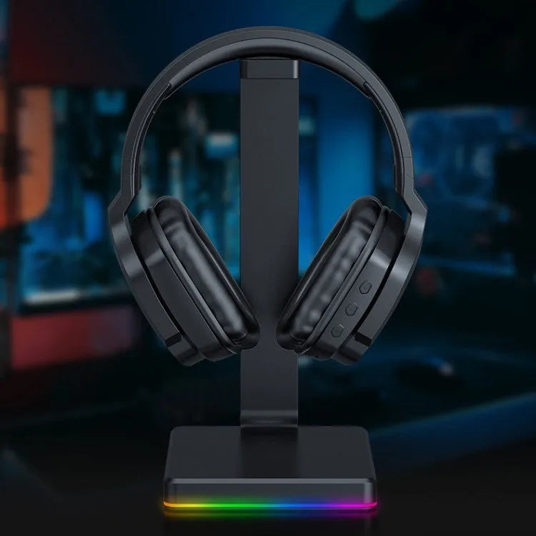 Luminous black wireless gaming headphones with head-mounted design showing ear cups and included 3.5mm cable