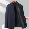 Man wearing a loose fit black casual coat for spring or autumn.