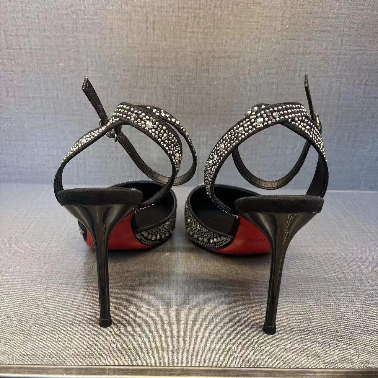 Women's black and silver hollow-cut stiletto heels with a pointed toe and shallow mouth design.