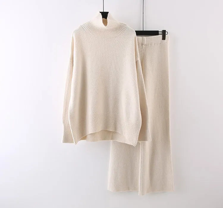 Women's beige acrylic knit sweater and wide-leg trousers two-piece set laid flat.