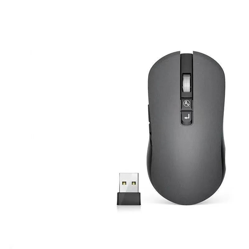IFLYTEK wireless gaming mouse with voice translation microphone on a desk next to a laptop.