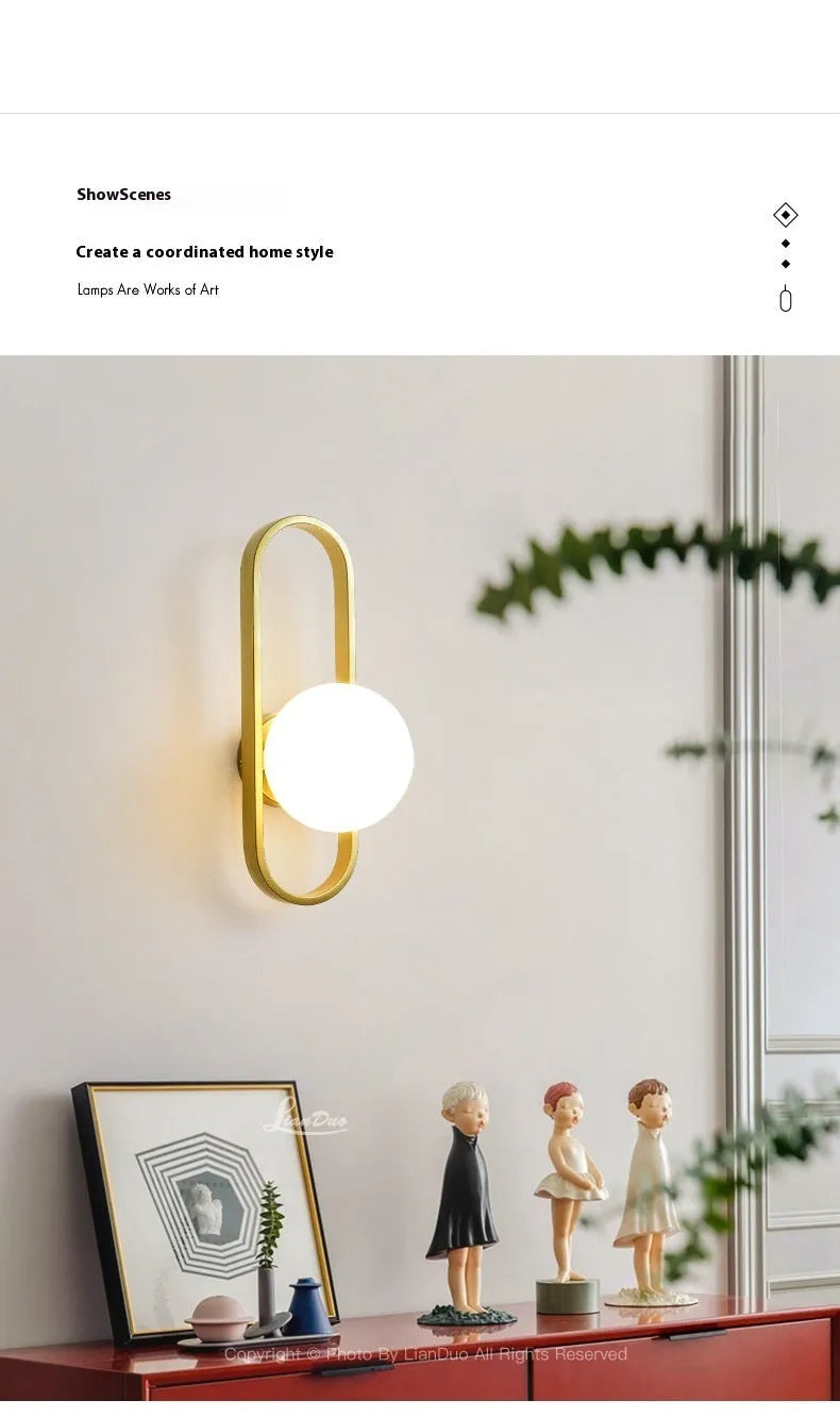 Minimalist wall-mounted lamp with glass shade and iron body in black or gold finish, showing 12W tri-colour LED light.