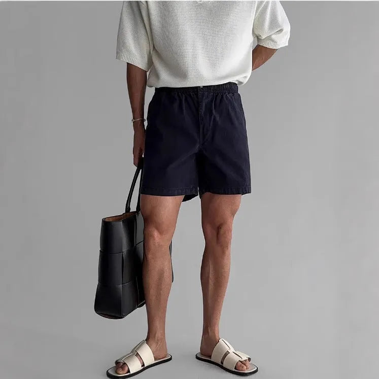 Men's cotton sports shorts in loose fit style available in black, white, and khaki colours