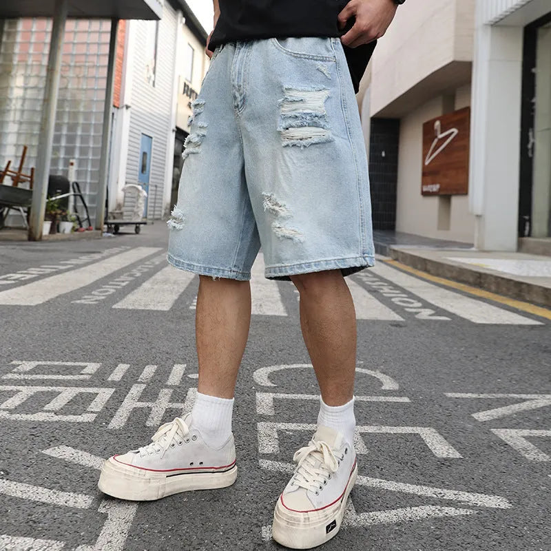 Light blue ripped denim shorts with distressed detailing and straight leg hip hop styling