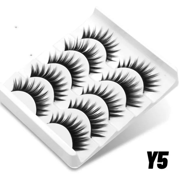 Box of natural false eyelashes with thick artificial fibre lashes and glue tube