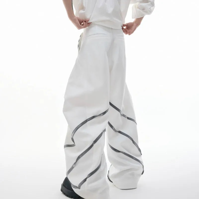 Men's black trousers with deconstructed three-dimensional cutting and metal rivets on the pleats
