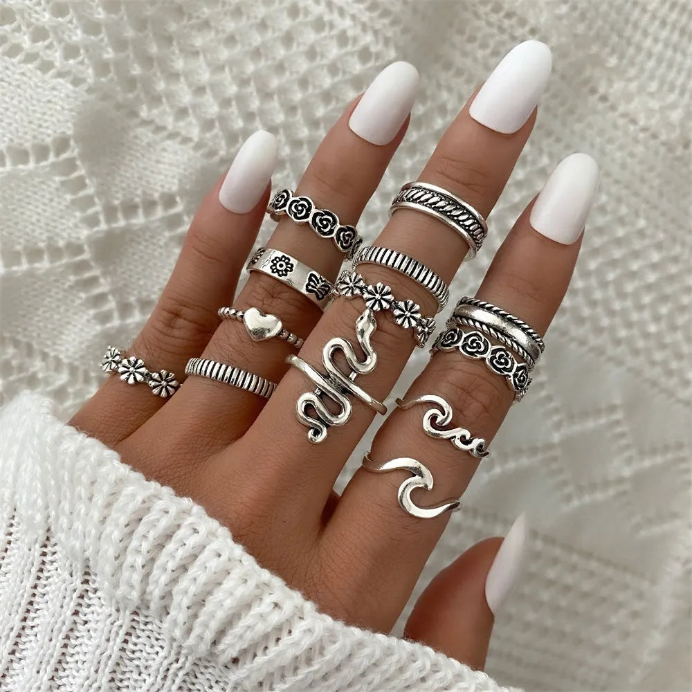 Alloy ring set with butterfly and snake retro geometric designs on display