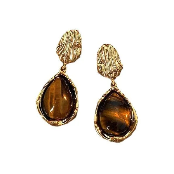 Set of three pairs of geometric alloy holiday ear studs with tassels in different styles.