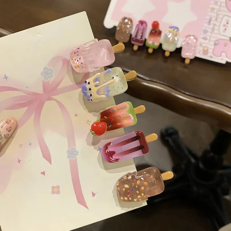 Cartoon ice cream design resin hair barrette clip in side view showing colour options.