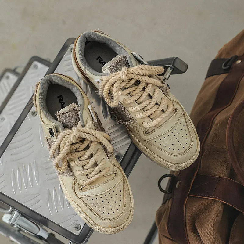 Beige low-top vintage skateboard shoes with microfiber upper and flat rubber sole.