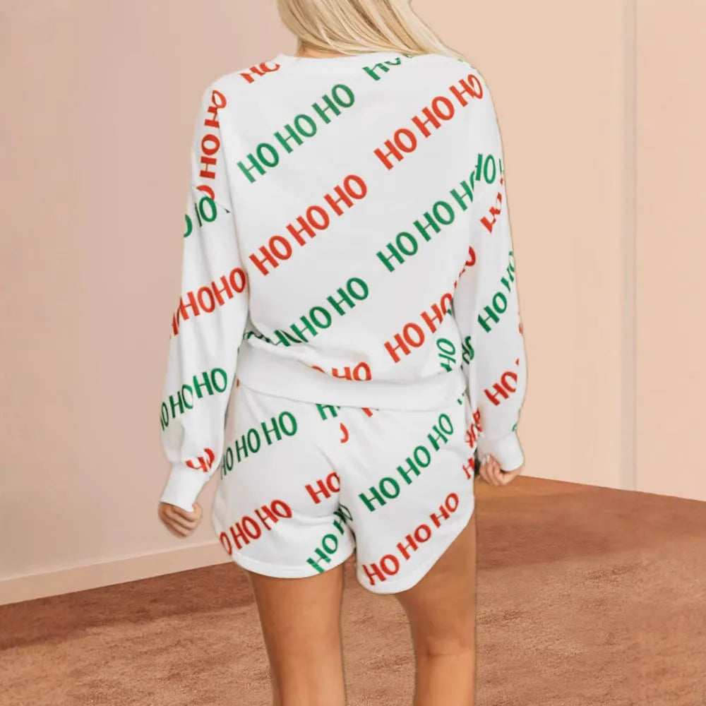 White women's two-piece street fashion suit with letters print on the long-sleeved top and matching trousers.