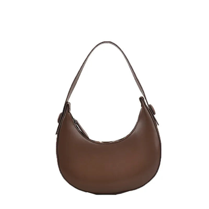 Retro-style dumpling-shaped PU leather shoulder bag in cream yellow showing front sandwich pocket.