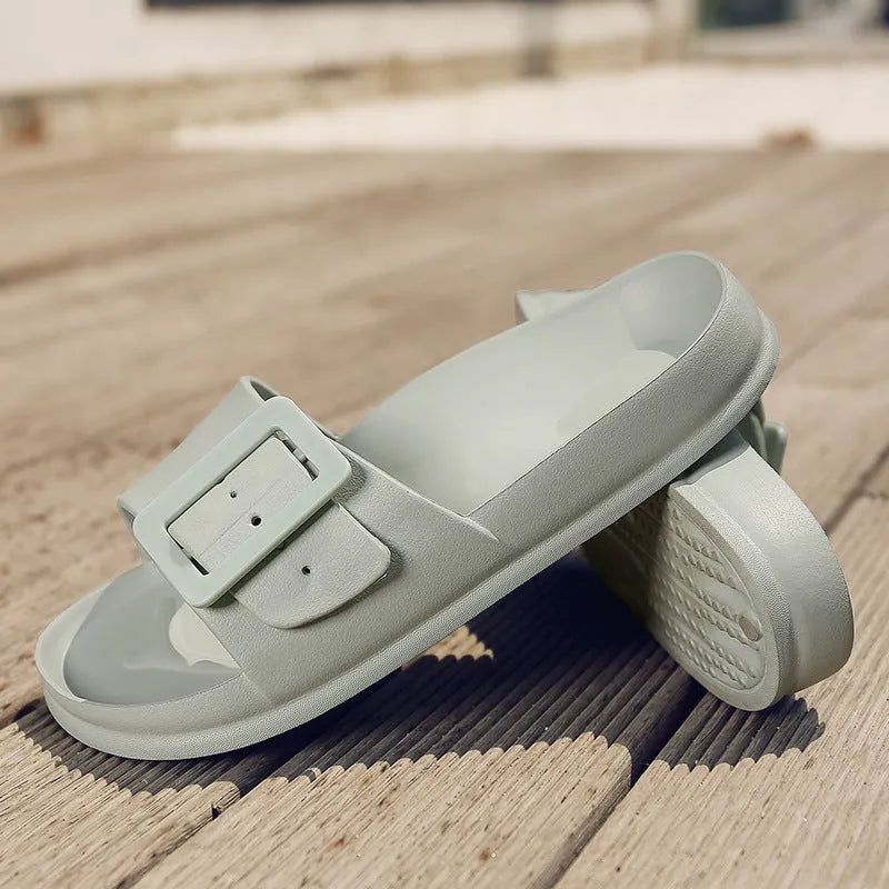 Women's grey blue EVA foam slippers with a buckle strap and soft sole.