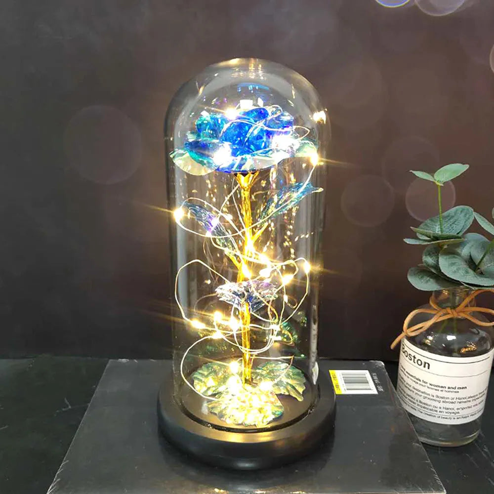 LED rose bouquet with glass lampshade showing warm white lights on simulation silk flowers.