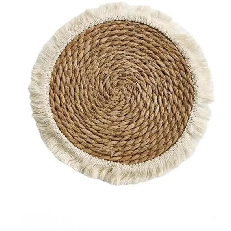 Round Japanese straw placemat with corn rope tassels in natural papyrus colour on wooden table