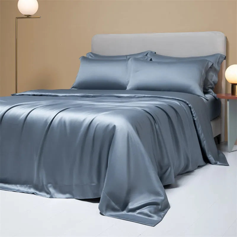 A modern, neatly made bed with a Lenzing Tencel duvet cover and pillowcases in a choice of nine colours like Sea Salt Blue.