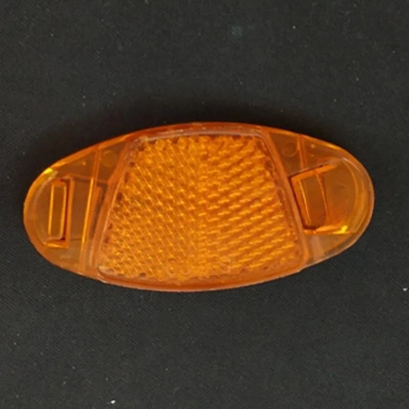 Yellow and white bicycle reflector decorations showing front and rear spoke mounting for night-time visibility