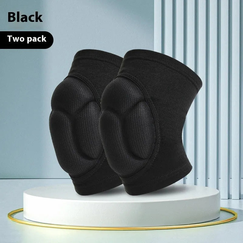 Pair of black thick sponge kneepads for dance and volleyball on a plain background