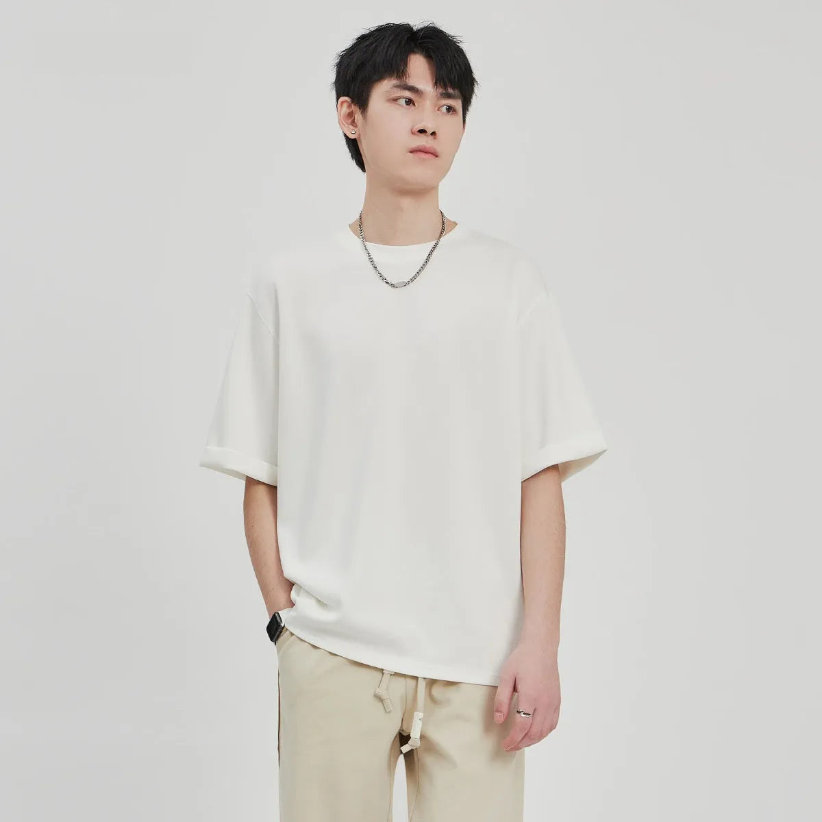 Men's brown loose drape knit casual T-shirt with short sleeves on a hanger.