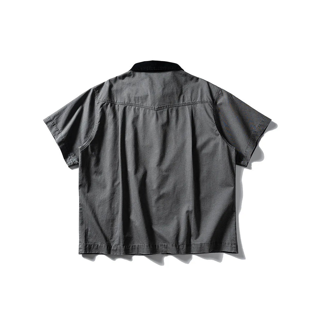Grey loose-fit short-sleeved cardigan-style overalls shirt on a hanger.