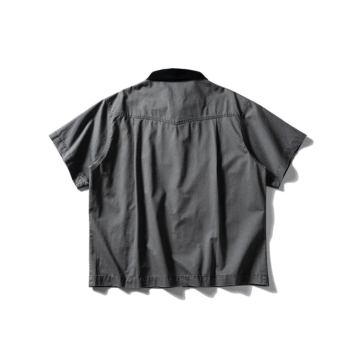 Grey loose-fit short-sleeved cardigan-style overalls shirt on a hanger.