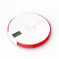 Blue seven-compartment electronic pill box with digital display and alarm clock, shown next to pills.