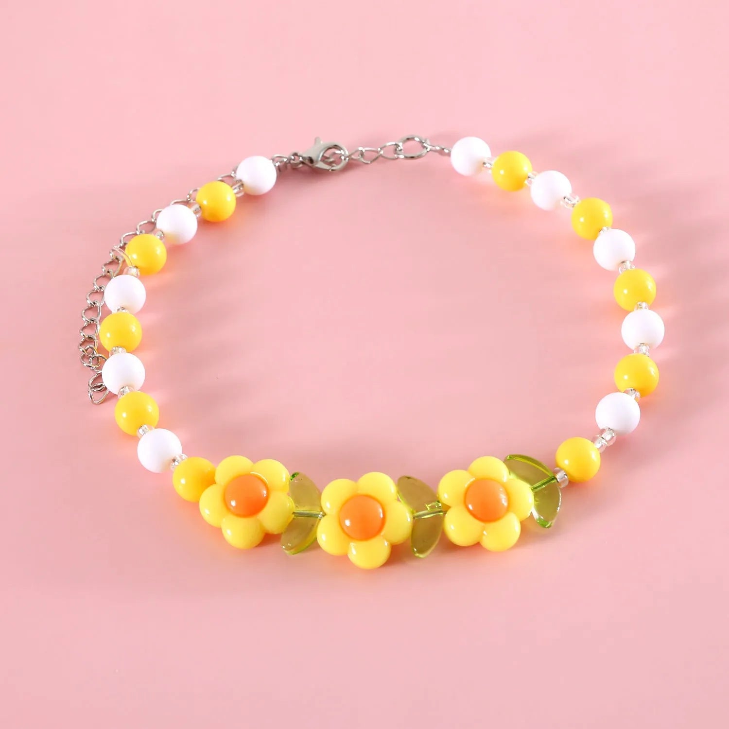 Colourful plastic bead cat collar with adjustable sizing in peach, rainbow, or small flower patterns