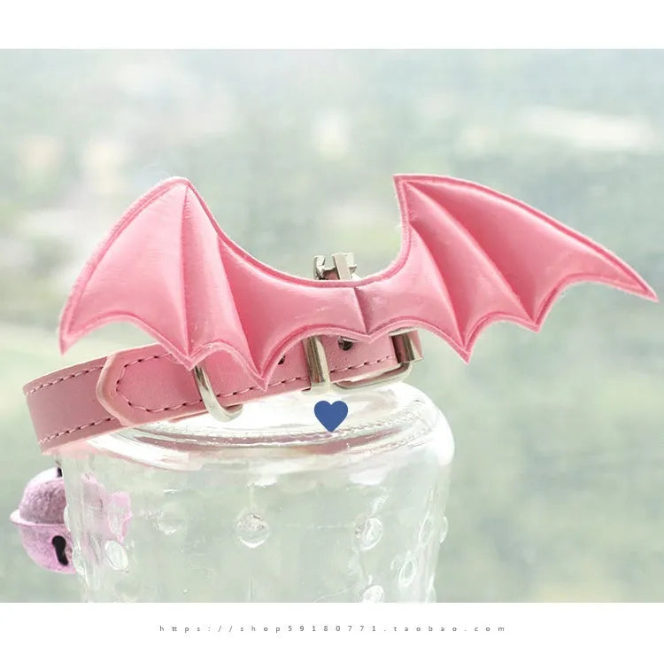 Leather dog collar with split devil wings design and bell attachment in patent leather satin material