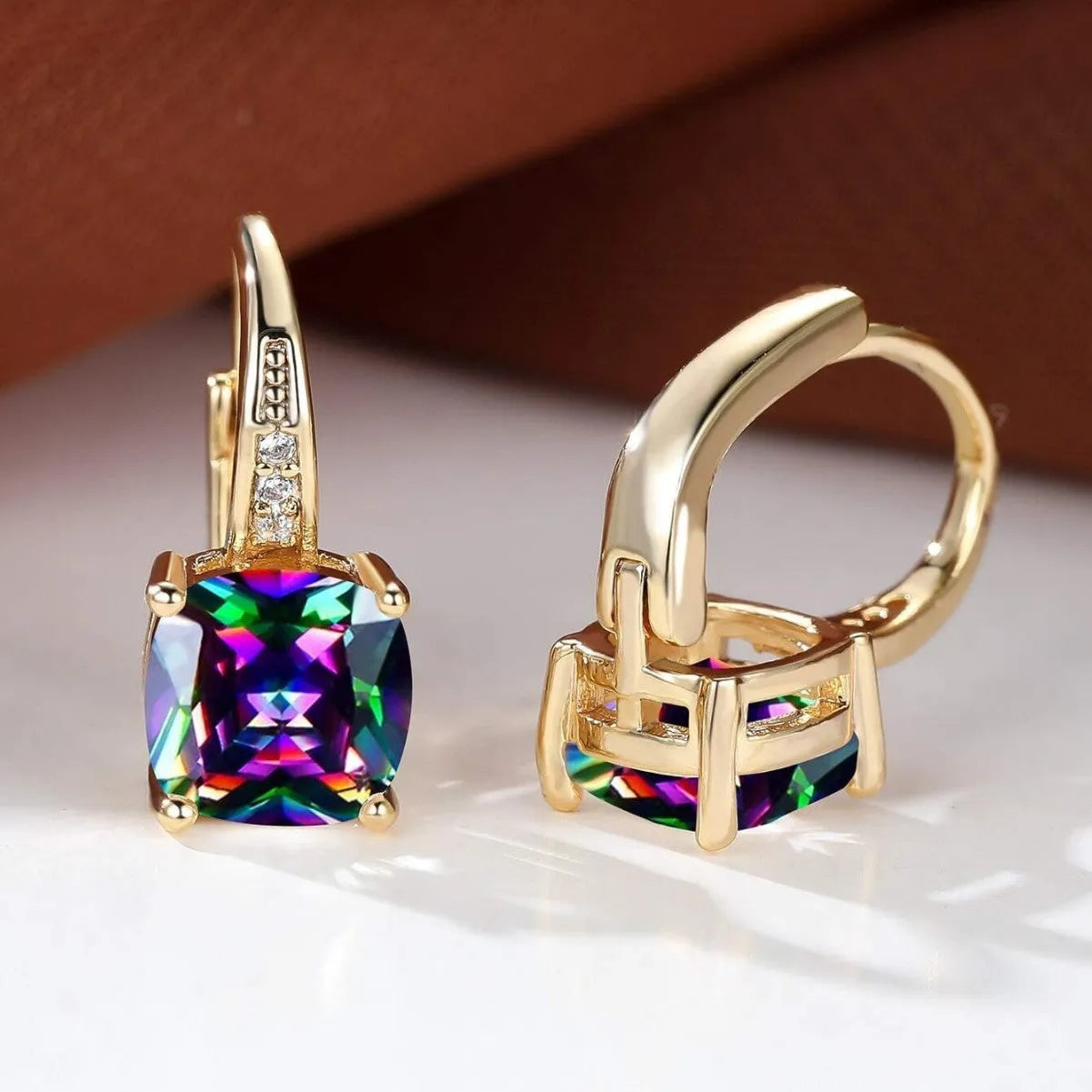 Square geometric gold ear clip with colourful moissanite stone inlay.
