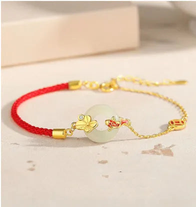 Gold koi peace buckle bracelet made from 925 silver with red rope closure