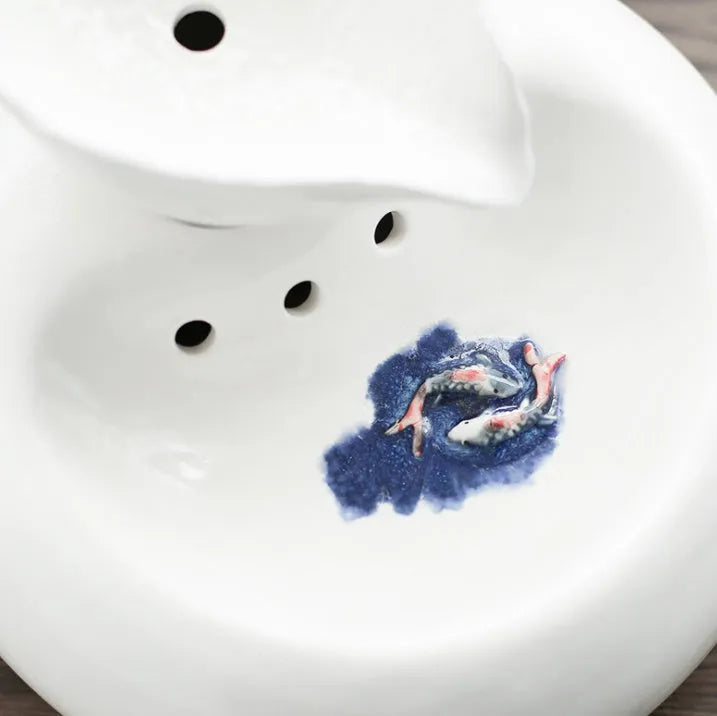White porcelain leaf-shaped automatic cat water dispenser on floor