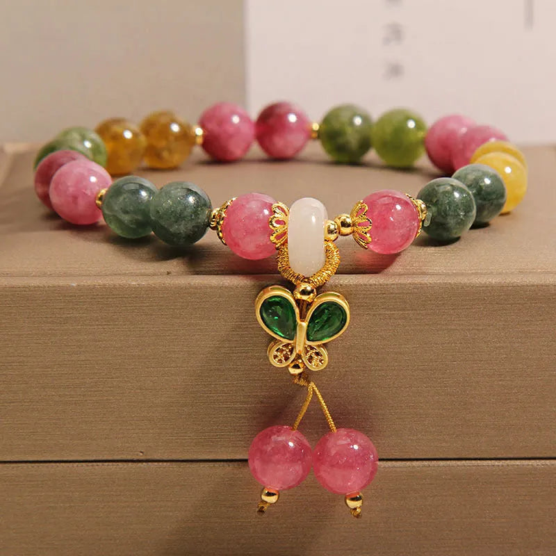 Women's tourmaline bracelet with colourful butterfly pendant and rhinestone detailing on adjustable chain
