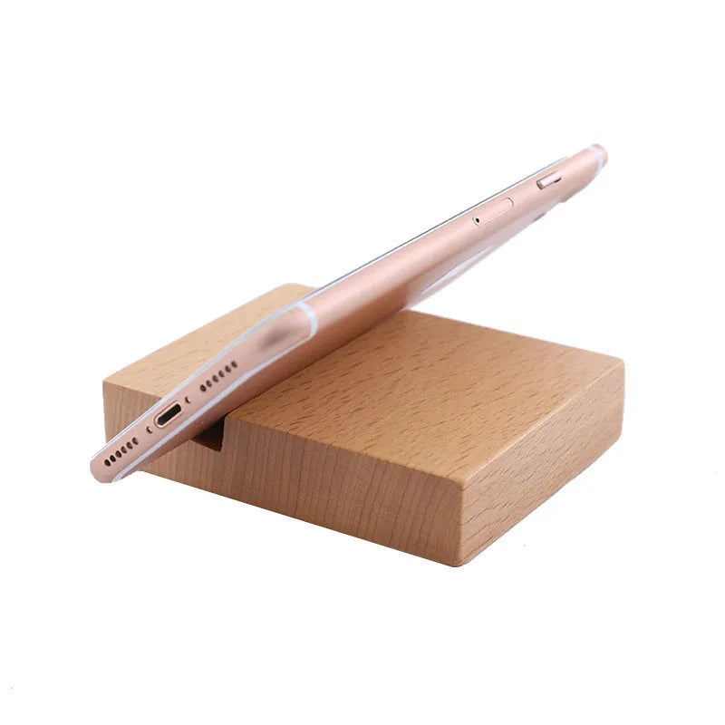 Solid beech wood phone holder with resin puppy decoration and a pound coin in the integrated slot.
