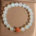 Women's blue agate and crystal bracelet with colourful lucky beads on a wrist.