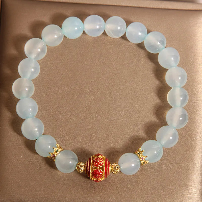 Women's blue agate and crystal bracelet with colourful lucky beads on a wrist.