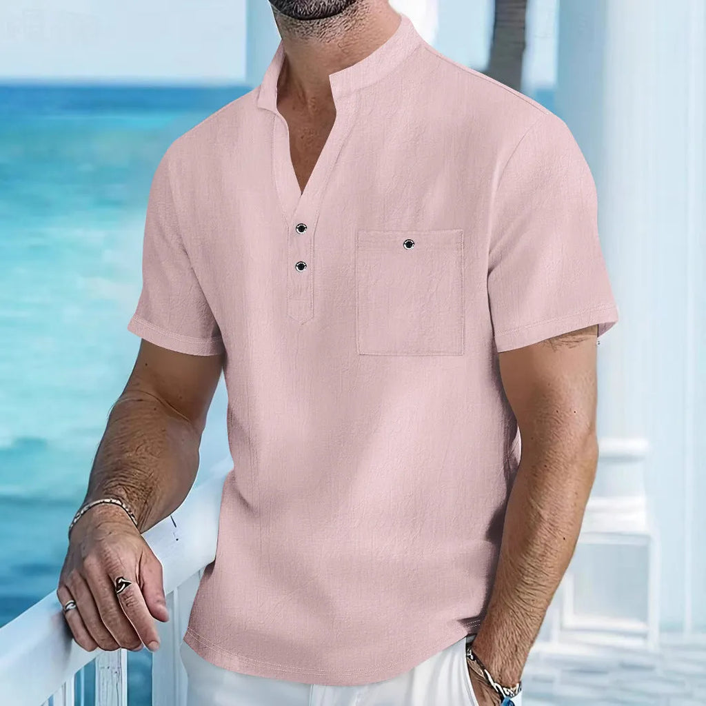 Man wearing a light-coloured linen blend T-shirt with a stand collar and short sleeves.