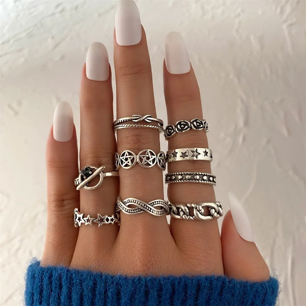 Alloy ring set with butterfly and snake retro geometric designs on display