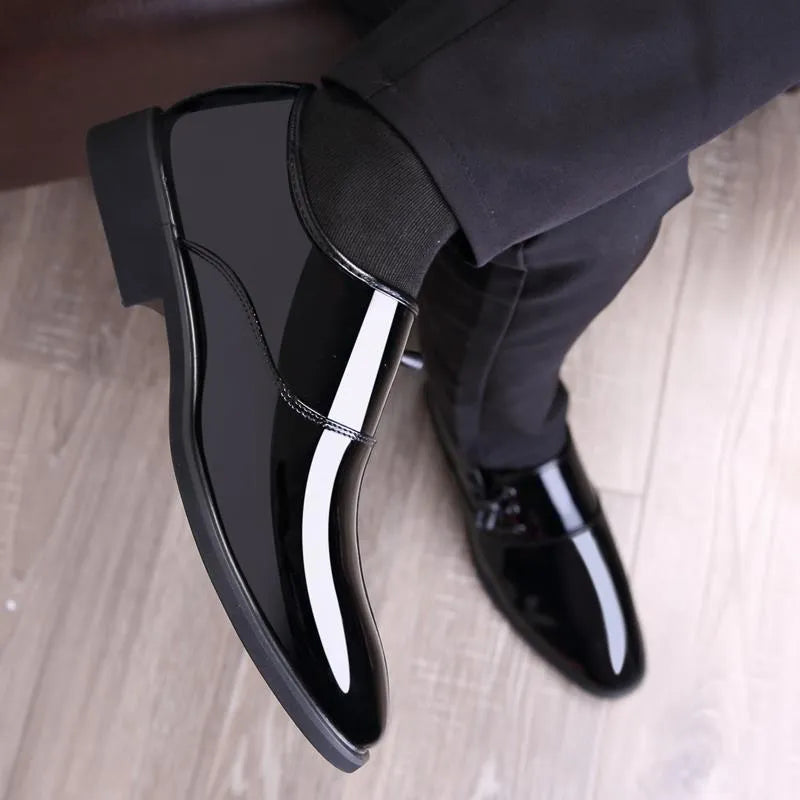 Men's black and brown formal business shoes with a square heel and round toe on a rubber sole.